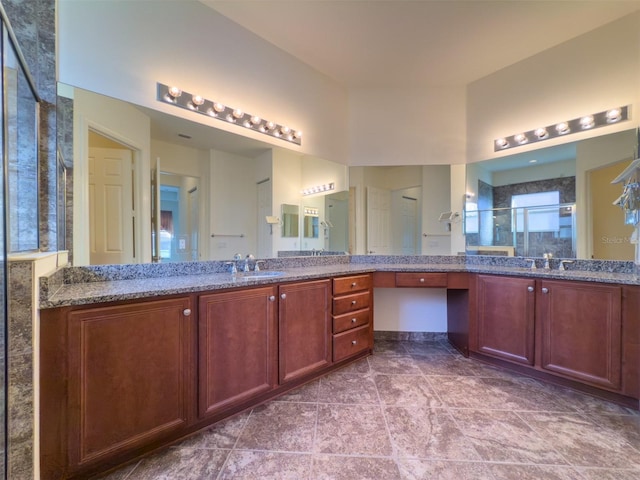 bathroom featuring tile patterned floors, vanity, and a shower with door