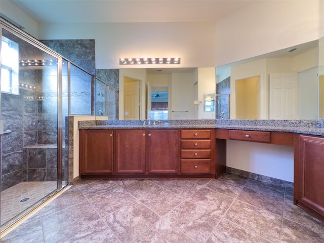 bathroom with tile patterned flooring, vanity, and a shower with shower door