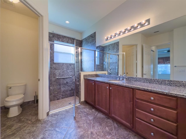 bathroom with tile patterned flooring, vanity, toilet, and an enclosed shower