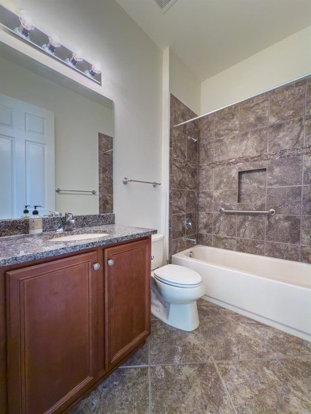 full bathroom featuring tile patterned flooring, vanity, toilet, and tiled shower / bath