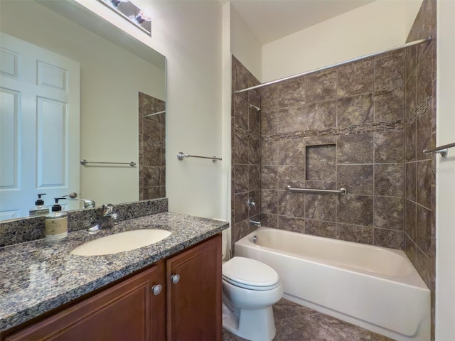 full bathroom with tile patterned floors, tiled shower / bath combo, toilet, and vanity