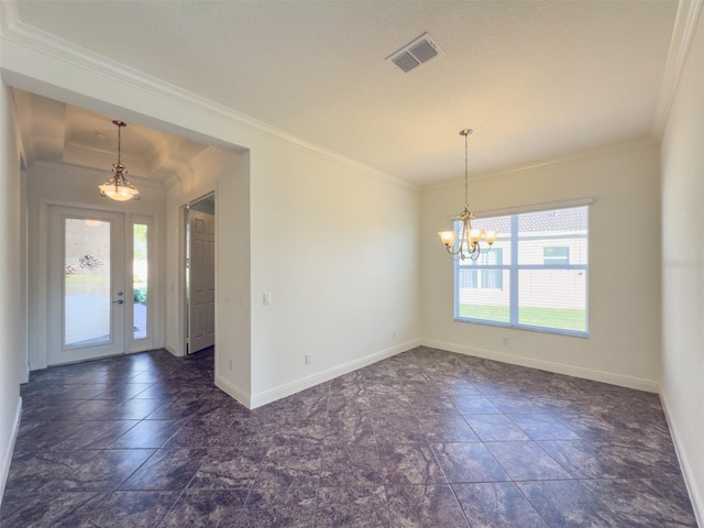 entrance foyer with a healthy amount of sunlight, a notable chandelier, and ornamental molding