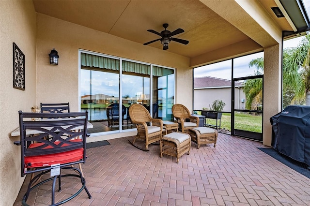 sunroom / solarium featuring ceiling fan, plenty of natural light, and a water view