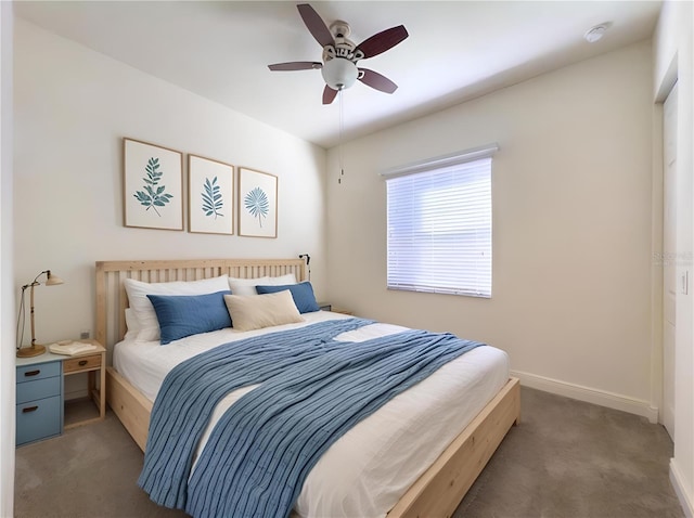 bedroom featuring dark colored carpet and ceiling fan