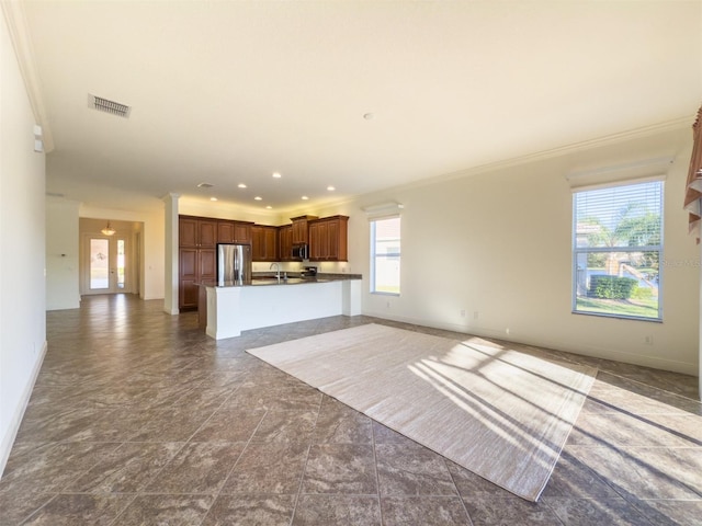 unfurnished living room featuring crown molding