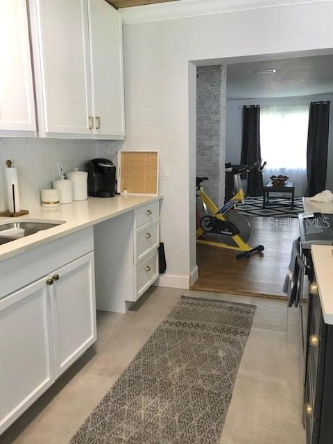 kitchen featuring white cabinets and ornamental molding