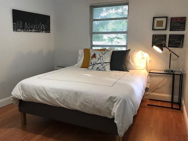 bedroom with wood-type flooring