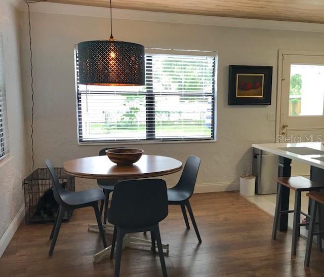 dining space with a wealth of natural light and hardwood / wood-style flooring