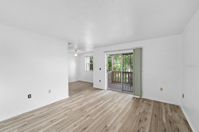 unfurnished room featuring a textured ceiling, light hardwood / wood-style flooring, and ceiling fan