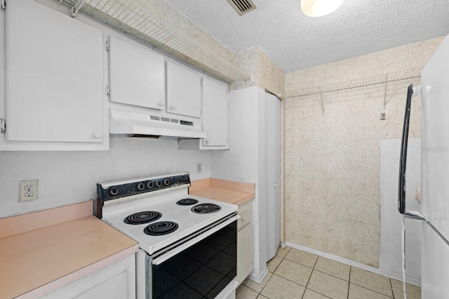 kitchen with a textured ceiling, white cabinetry, light tile patterned floors, and white electric range