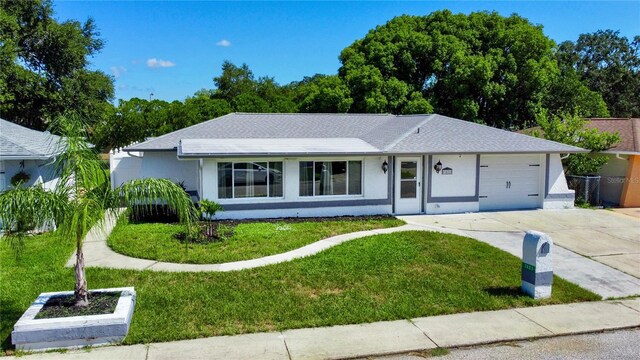 ranch-style house featuring a front lawn and a garage