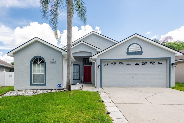 single story home featuring a garage and a front yard