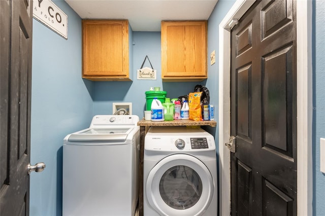 laundry area featuring cabinets and washer and dryer