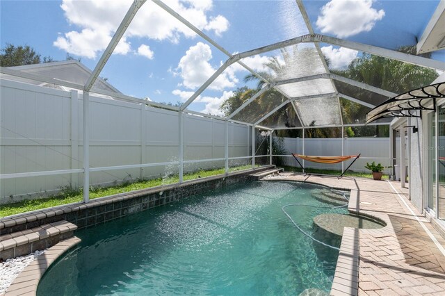 view of swimming pool with a lanai and a patio