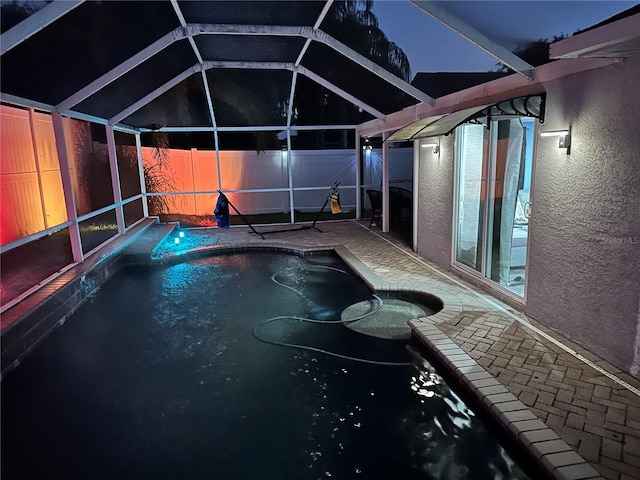 view of pool at twilight