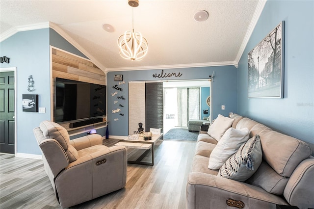 living room featuring ornamental molding, vaulted ceiling, a textured ceiling, and light hardwood / wood-style floors