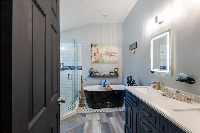 bathroom featuring vanity, lofted ceiling, hardwood / wood-style flooring, and plus walk in shower