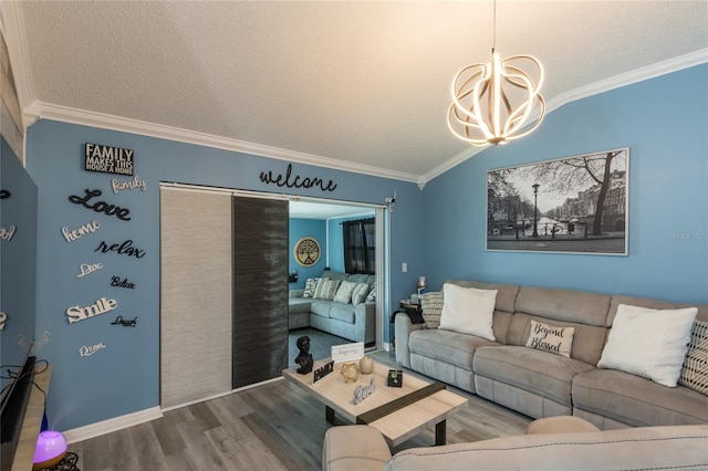 living room featuring a textured ceiling, crown molding, a chandelier, and hardwood / wood-style flooring