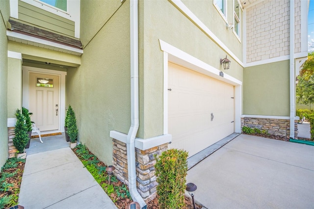 view of exterior entry featuring a garage