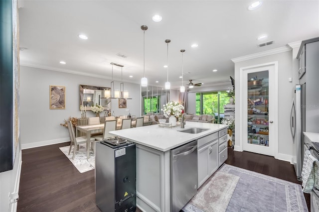 kitchen featuring a center island with sink, pendant lighting, appliances with stainless steel finishes, dark wood-type flooring, and gray cabinets