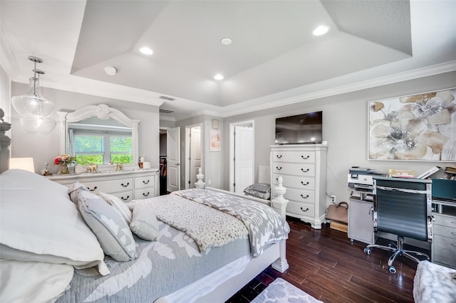 bedroom with ornamental molding, a raised ceiling, and dark wood-type flooring