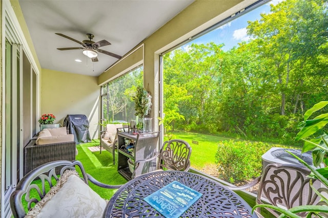 sunroom featuring ceiling fan