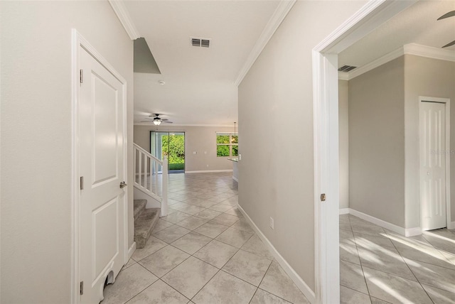 corridor with crown molding and light tile patterned flooring