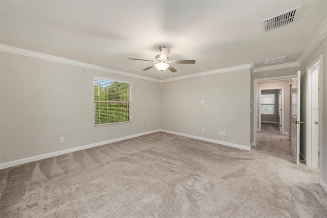 carpeted empty room featuring crown molding and ceiling fan