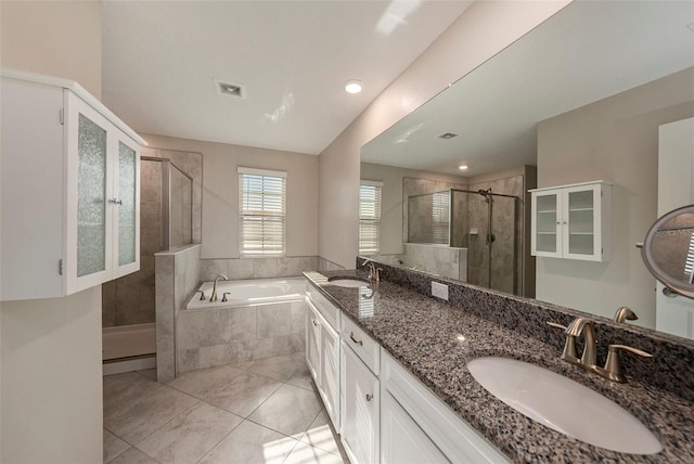 bathroom with tile patterned flooring, shower with separate bathtub, and vanity