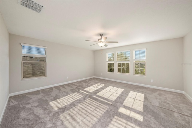 unfurnished room with ceiling fan and light carpet