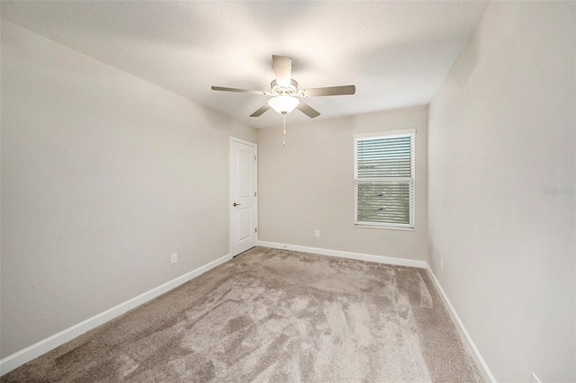 carpeted spare room with a textured ceiling and ceiling fan