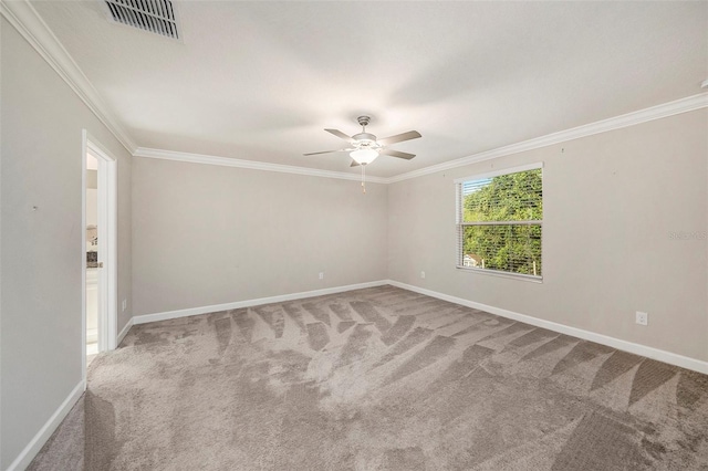 empty room featuring ceiling fan, ornamental molding, and carpet floors