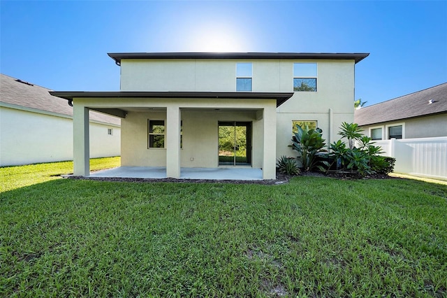 rear view of property with a yard and a patio