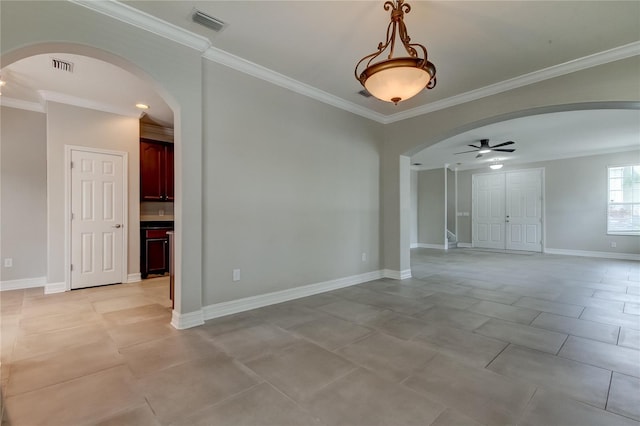 tiled empty room featuring ornamental molding and ceiling fan