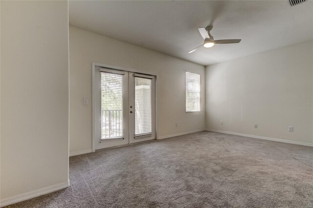 empty room with french doors, carpet, and ceiling fan