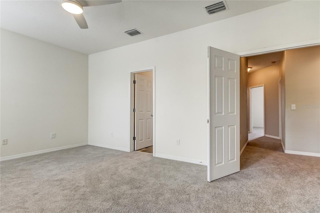 unfurnished bedroom featuring ceiling fan and light carpet