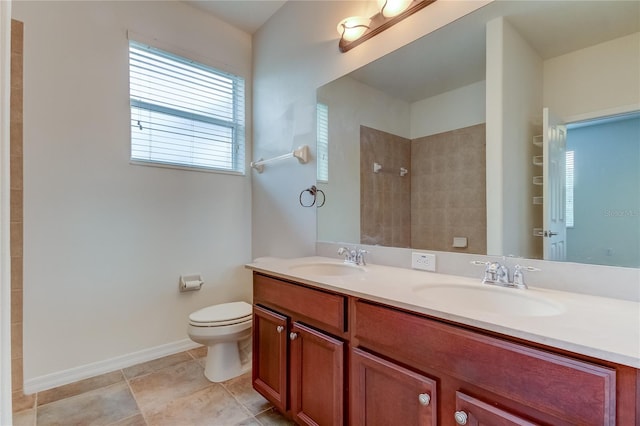 bathroom featuring tiled shower, vanity, toilet, and tile patterned floors