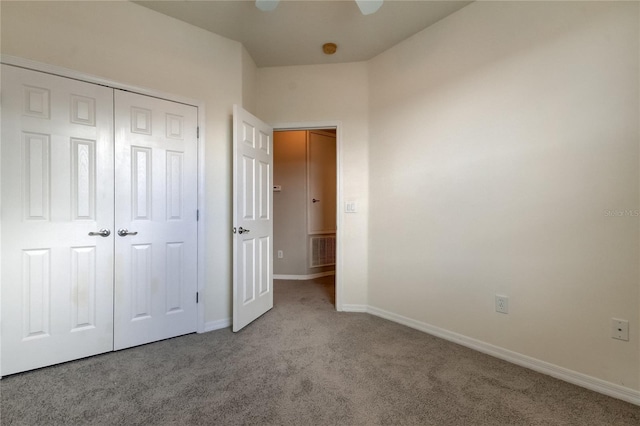 unfurnished bedroom featuring ceiling fan, light colored carpet, and a closet