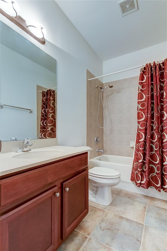 full bathroom with vanity, toilet, tile patterned floors, and shower / bath combo