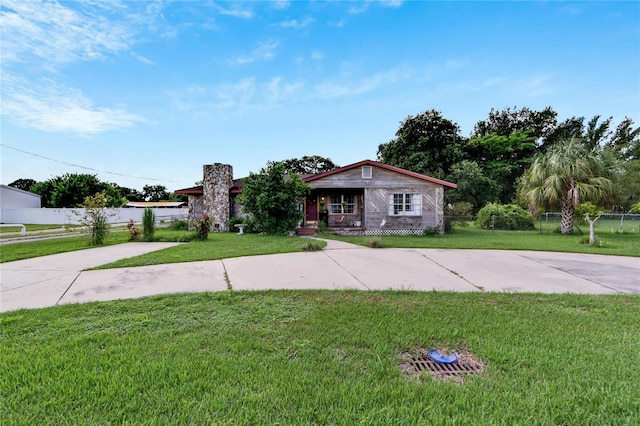 ranch-style home featuring a front yard