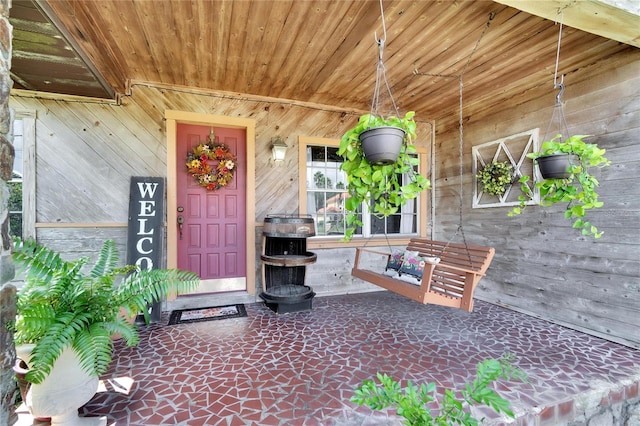 doorway to property featuring covered porch