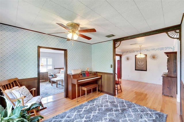 sitting room with ceiling fan and light wood-type flooring