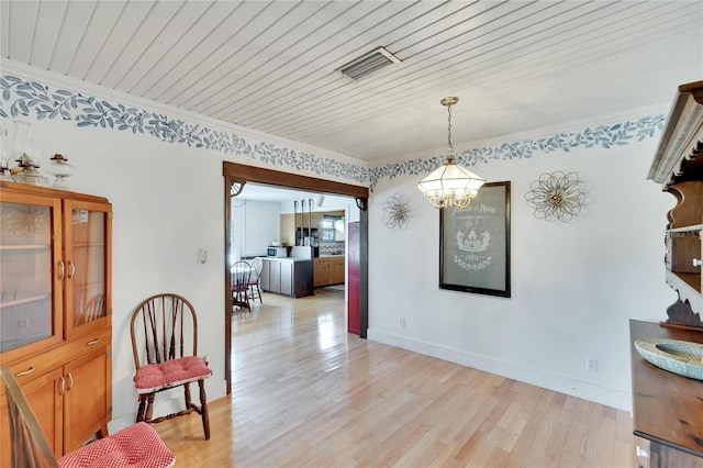 dining room featuring wooden ceiling, ornamental molding, hardwood / wood-style floors, and a notable chandelier