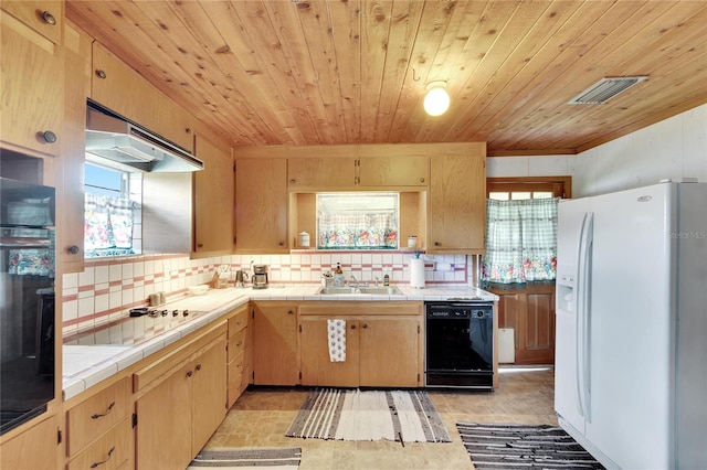 kitchen featuring black appliances, tasteful backsplash, tile counters, wood ceiling, and sink