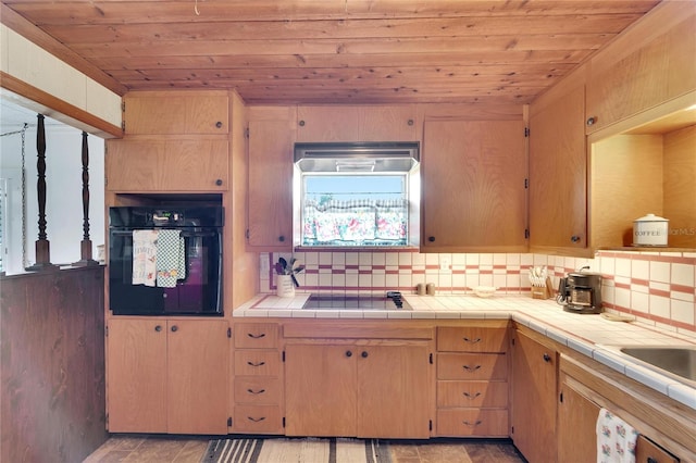 kitchen featuring black appliances, backsplash, wood ceiling, and tile countertops