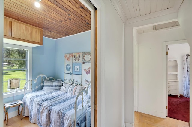 bedroom with wood ceiling, multiple windows, and light parquet flooring