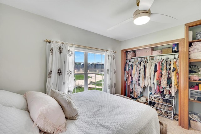 bedroom featuring a closet, ceiling fan, and light carpet