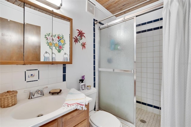 bathroom with a shower with shower door, toilet, tile walls, and vanity