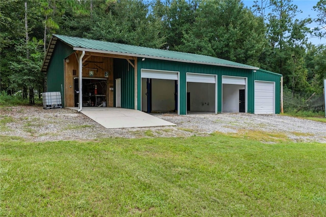 garage featuring a lawn and wood walls