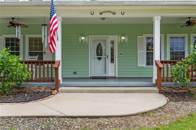 view of exterior entry with a porch and ceiling fan